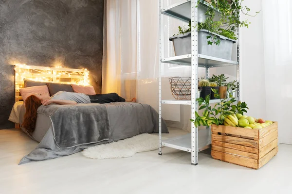 Woman lying on bed in apartment — Stock Photo, Image