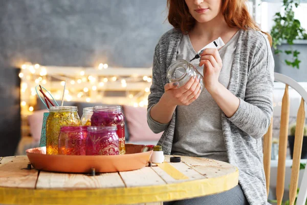 Woman painting jar at home — Stock Photo, Image