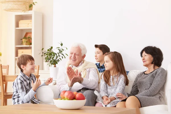Grandparents playing with grandchildren — Stock Photo, Image