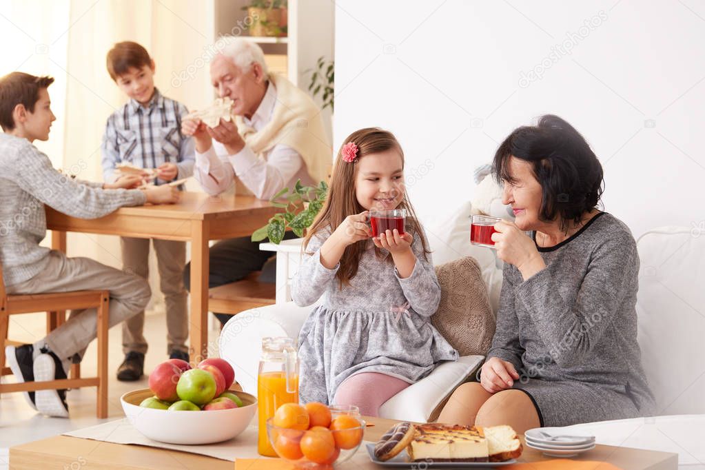 Grandmother and granddaughter drinking tea