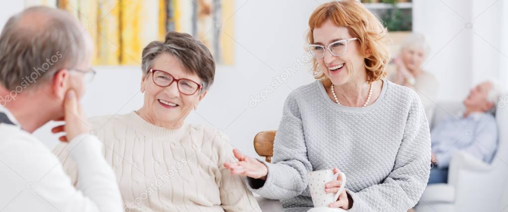 Senior women talking to man