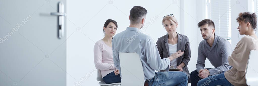 Man confiding to psychotherapy group