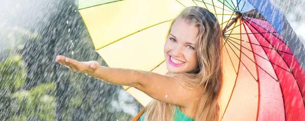 Pretty blonde girl with colorful umbrella — Stock Photo, Image