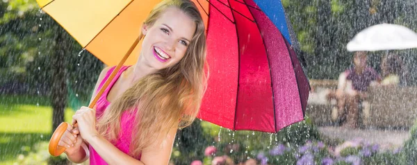 Optimistic woman with colorful umbrella — Stock Photo, Image