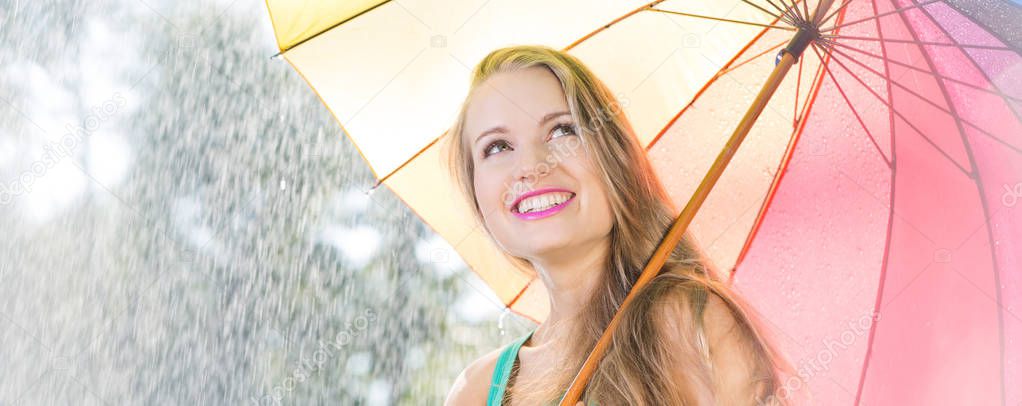 Happy blonde student during summer rain