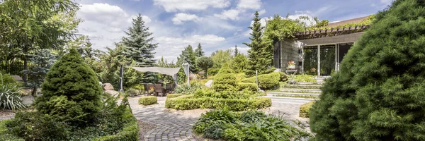 Spacious garden with wooden furniture