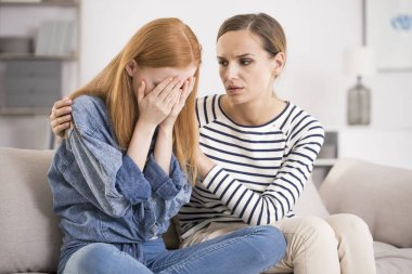 Depressed woman comforted by friend clipart