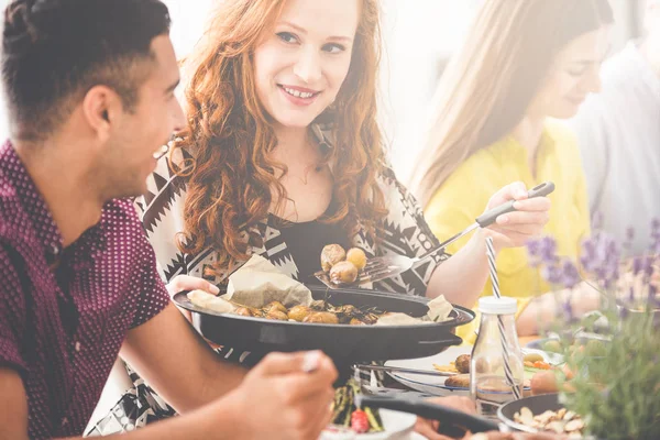 Red haired woman shares meal