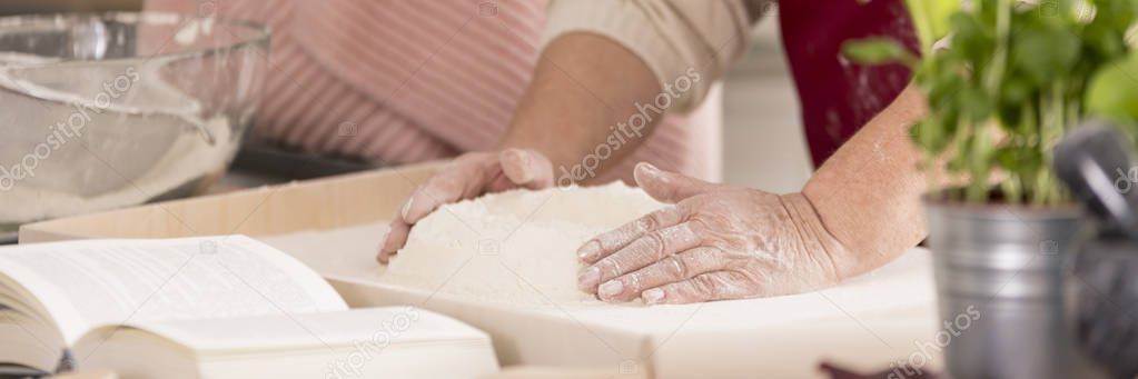 Grandmother preparing dough