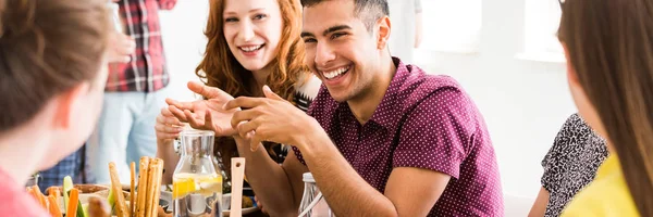 Friends chatting by dinner table — Stock Photo, Image