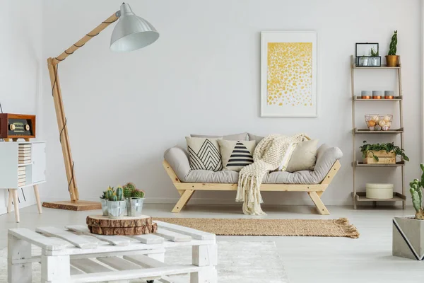 Yellow painting hangs over sofa — Stock Photo, Image