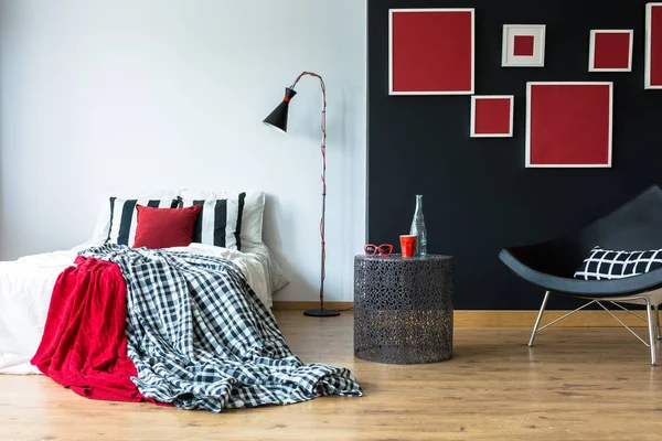 Cozy bedroom with red paintings — Stock Photo, Image