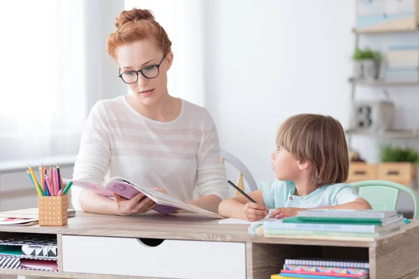Boy and teacher in classroom — Stock Photo, Image
