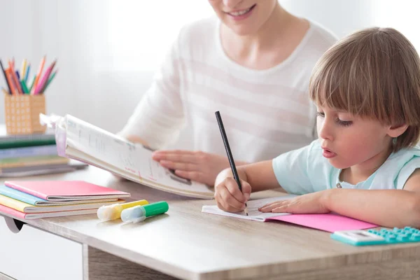 Boy focusing on homework — Stock Photo, Image