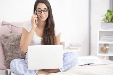 Telefonla konuşurken gülümseyen kız