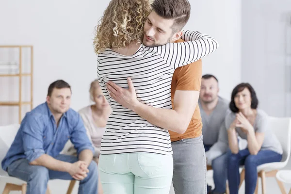 Couple hugging during marital therapy