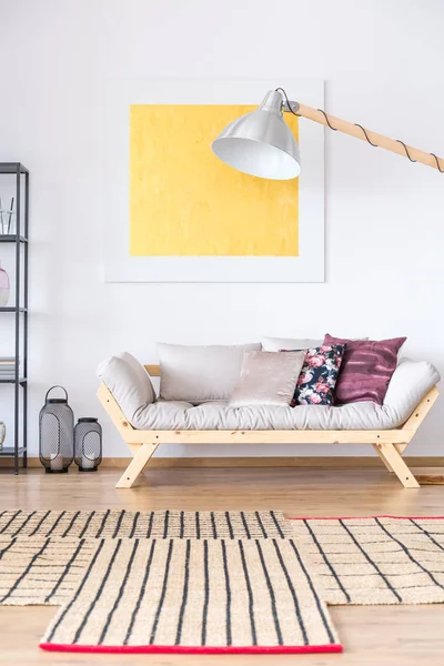 Beige sofa with floral pillow