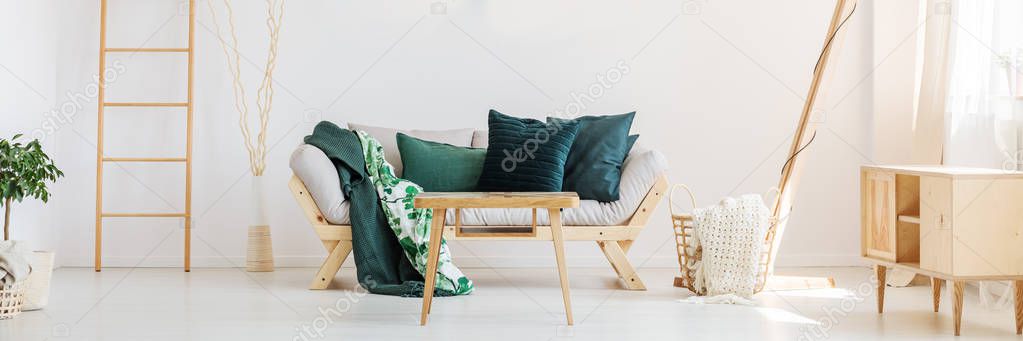 Sofa with moss green pillows