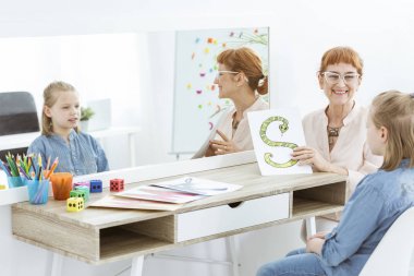 Speech therapist showing an image clipart