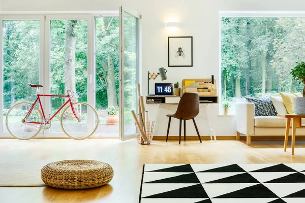 Bicicleta y puf en la habitación — Foto de Stock