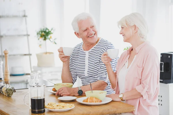 Smiling marriage of elders eat breakfast