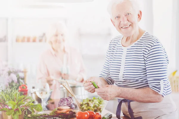 Smiling elder man in striped shirt