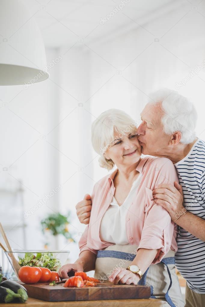  Grandpa kisses grandma on the cheek