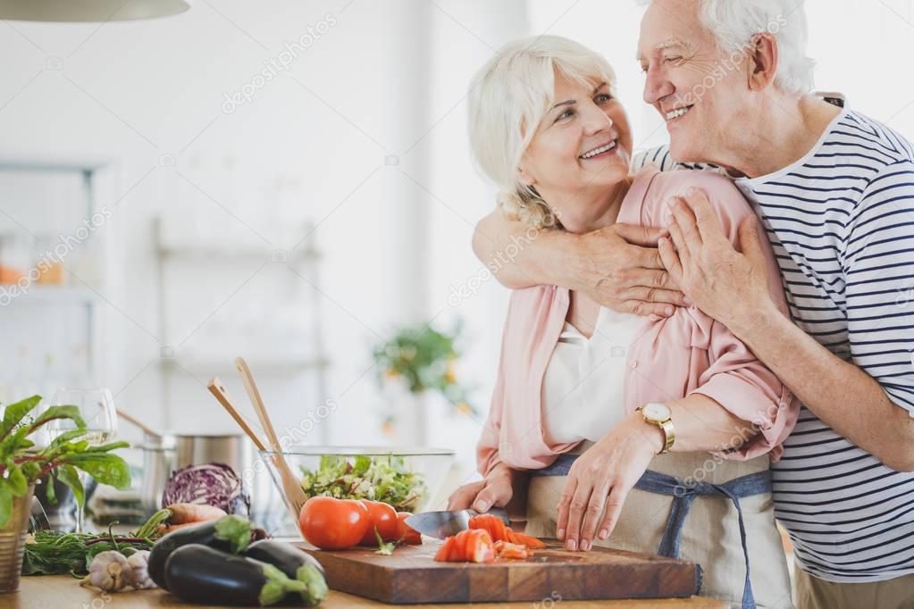 Happy vegan couple is making lunch