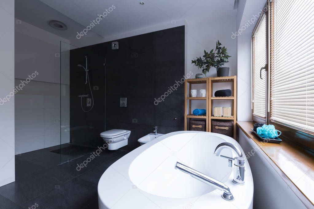 Modern bathroom with black tiles