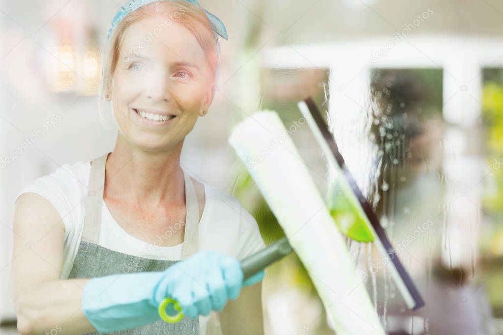 Female cleaner with a squeegee