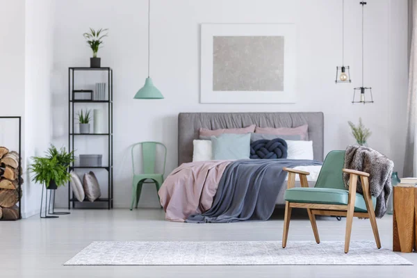 Mint chair next to bed — Stock Photo, Image