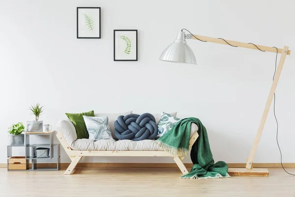 Wooden couch and green blanket — Stock Photo, Image
