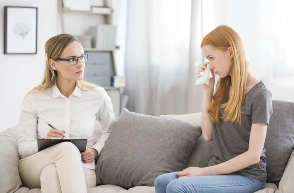 Girl wiping tears during psychotherapy — Stock Photo, Image