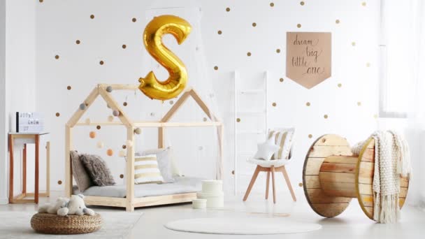 Gold balloon above handmade bed — Stock Video