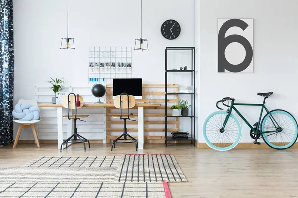 Espaço de trabalho espaçoso com bicicleta — Fotografia de Stock