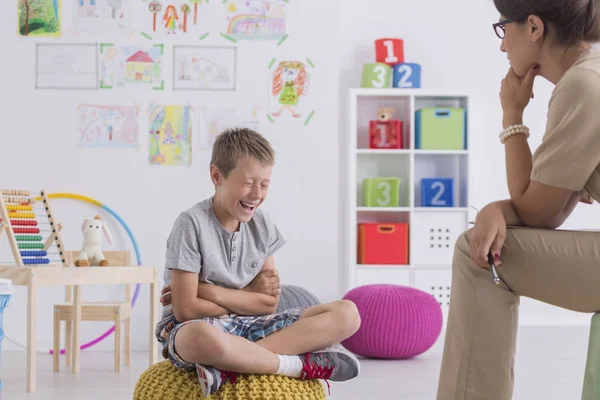 Young boy sits on a yellow pouf — Stock Photo, Image