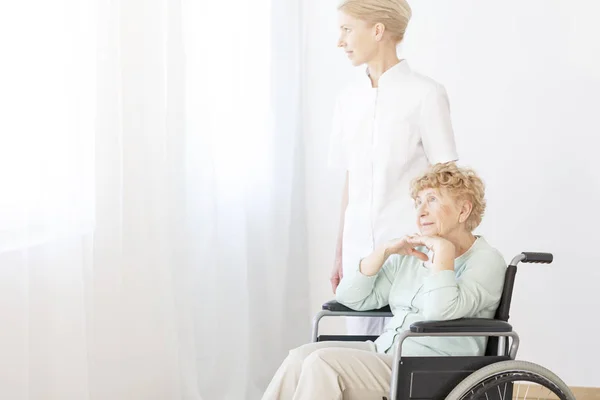 Sjuksköterska medhjälpande senior kvinna — Stockfoto
