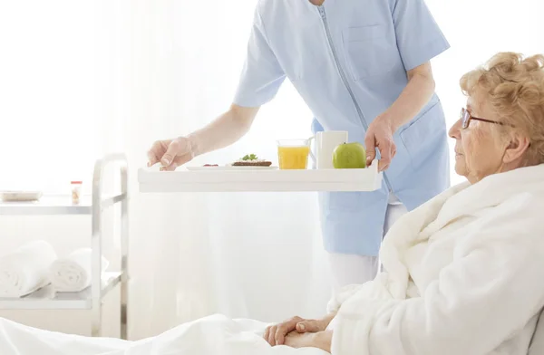 Asistente para llevar comida a ancianos — Foto de Stock