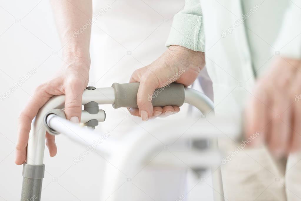 Elderly person using walker