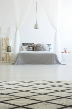 Patterned carpet in spacious bedroom clipart