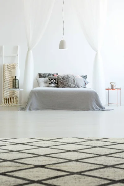 Patterned carpet in spacious bedroom