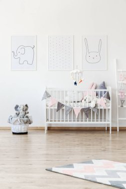 Hayvan posterler yatak üzerinde asılı