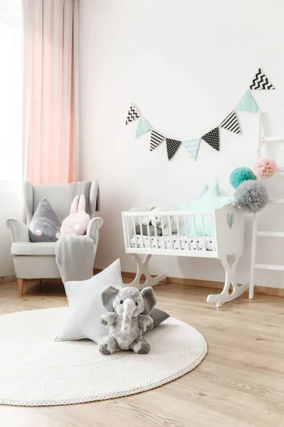 Plush elephant sitting on carpet — Stock Photo, Image