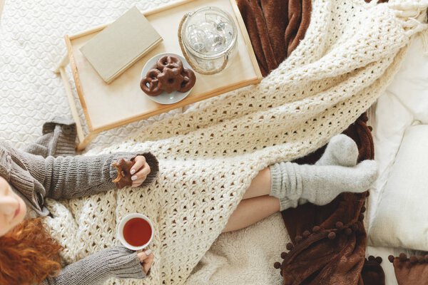 Girl eating gingerbread with tea