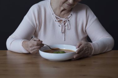 Elderly person with appetite disorders clipart