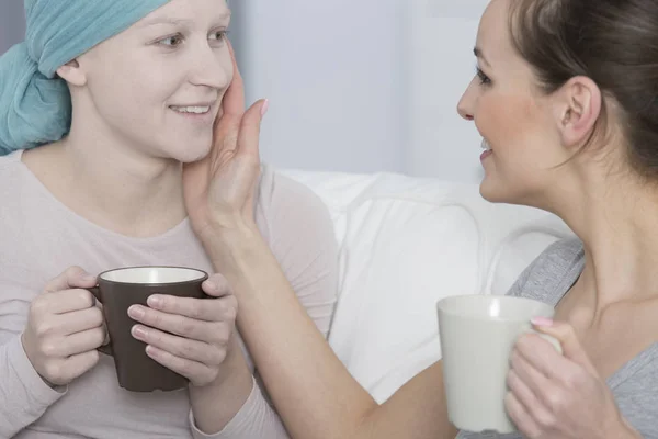 Woman stroking friend's pale face — Stock Photo, Image