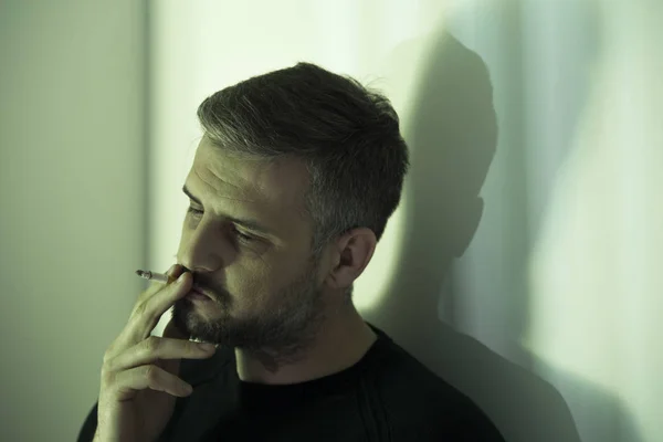 Nervous man smoking cigarette — Stock Photo, Image