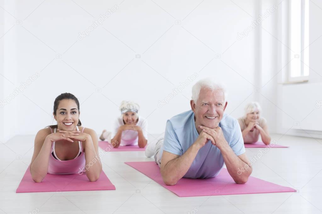 Seniors and yoga instructor