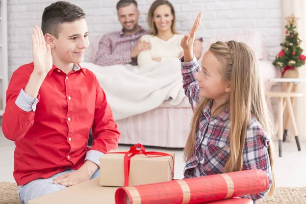 Siblings upacking gifts from Santa — Stock Photo, Image