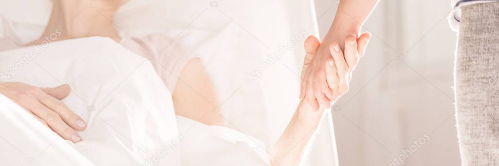 Girl holding mother's hand